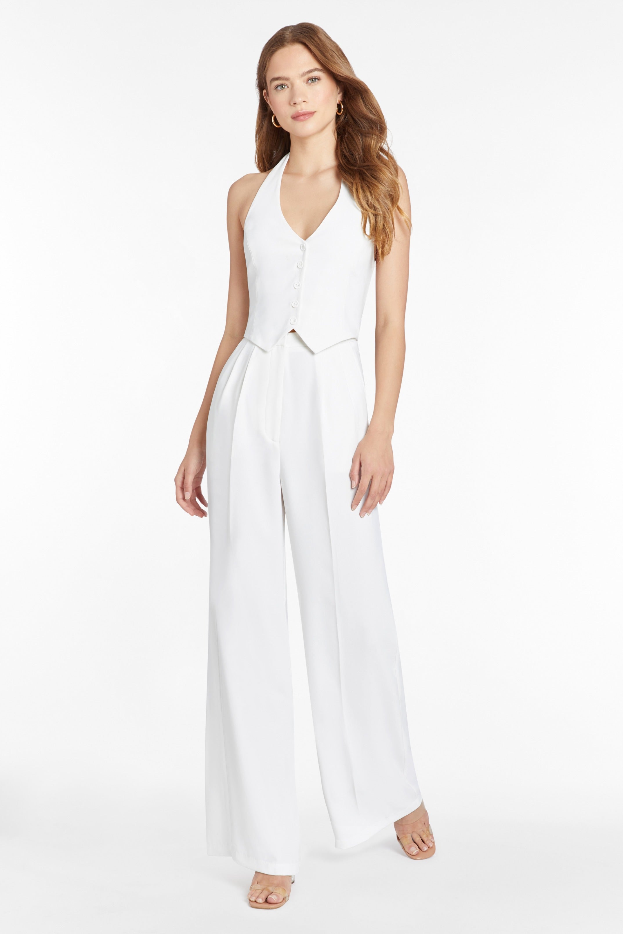 Girl in white jumpsuit, front facing.