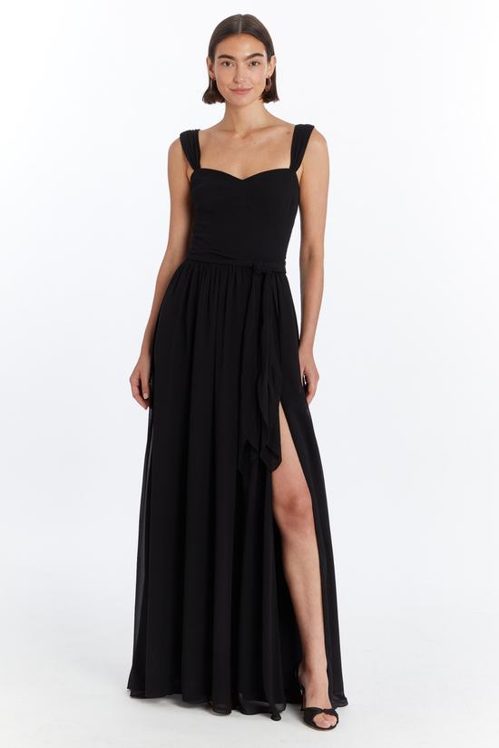 Girl in long black maxi dress with slit, front facing. view 1