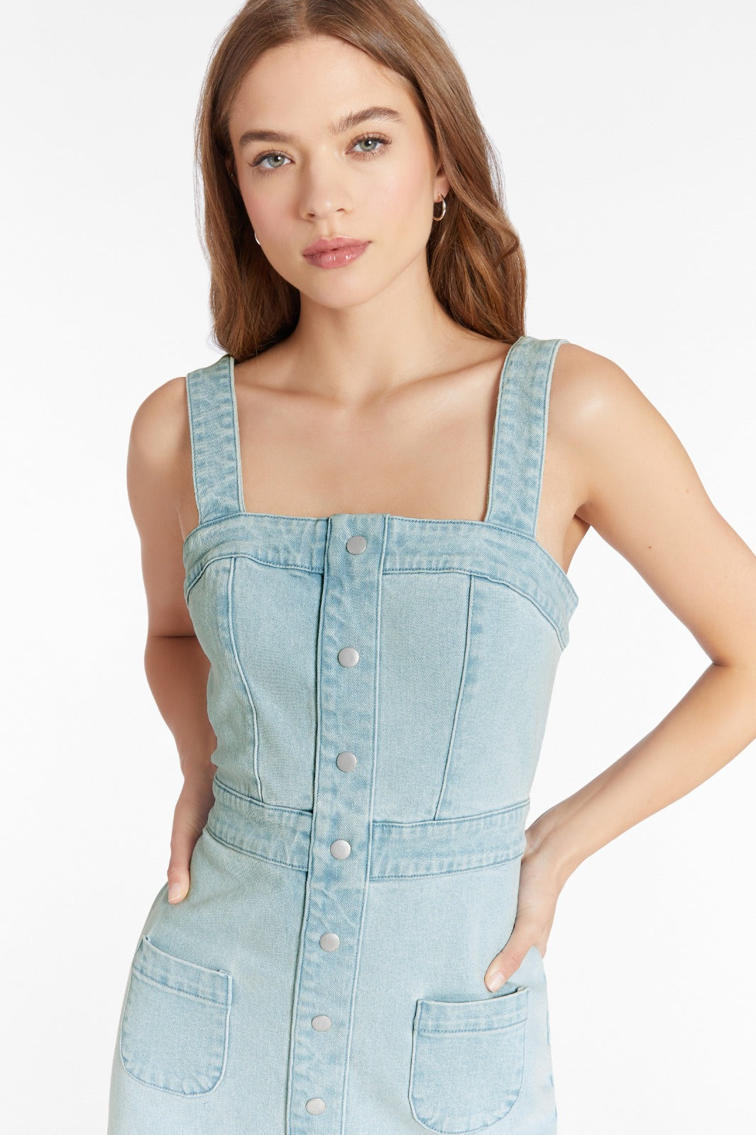 Girl in denim dress, front facing.