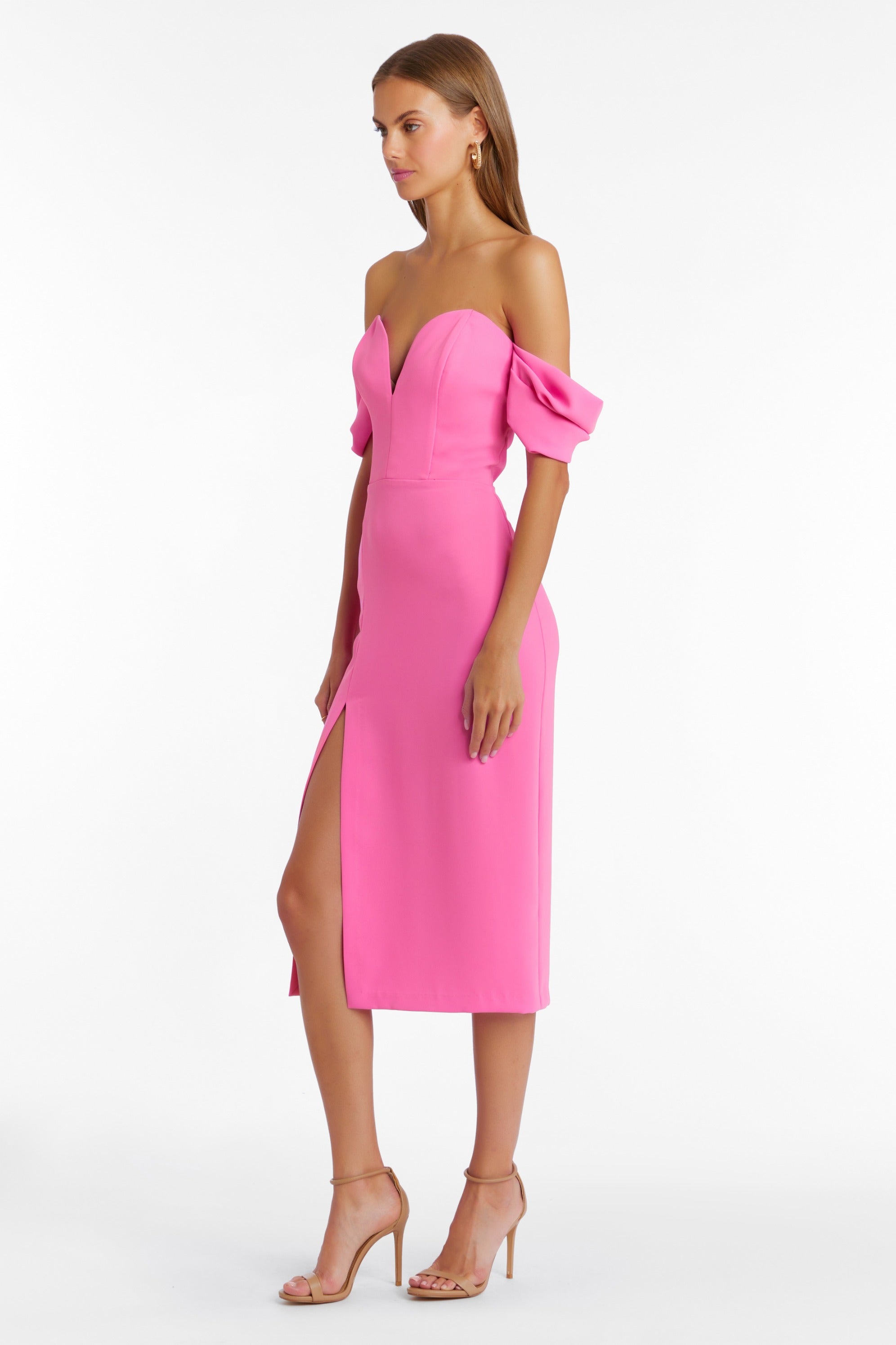 Girl in hot pink off the shoulder midi dress, side facing.