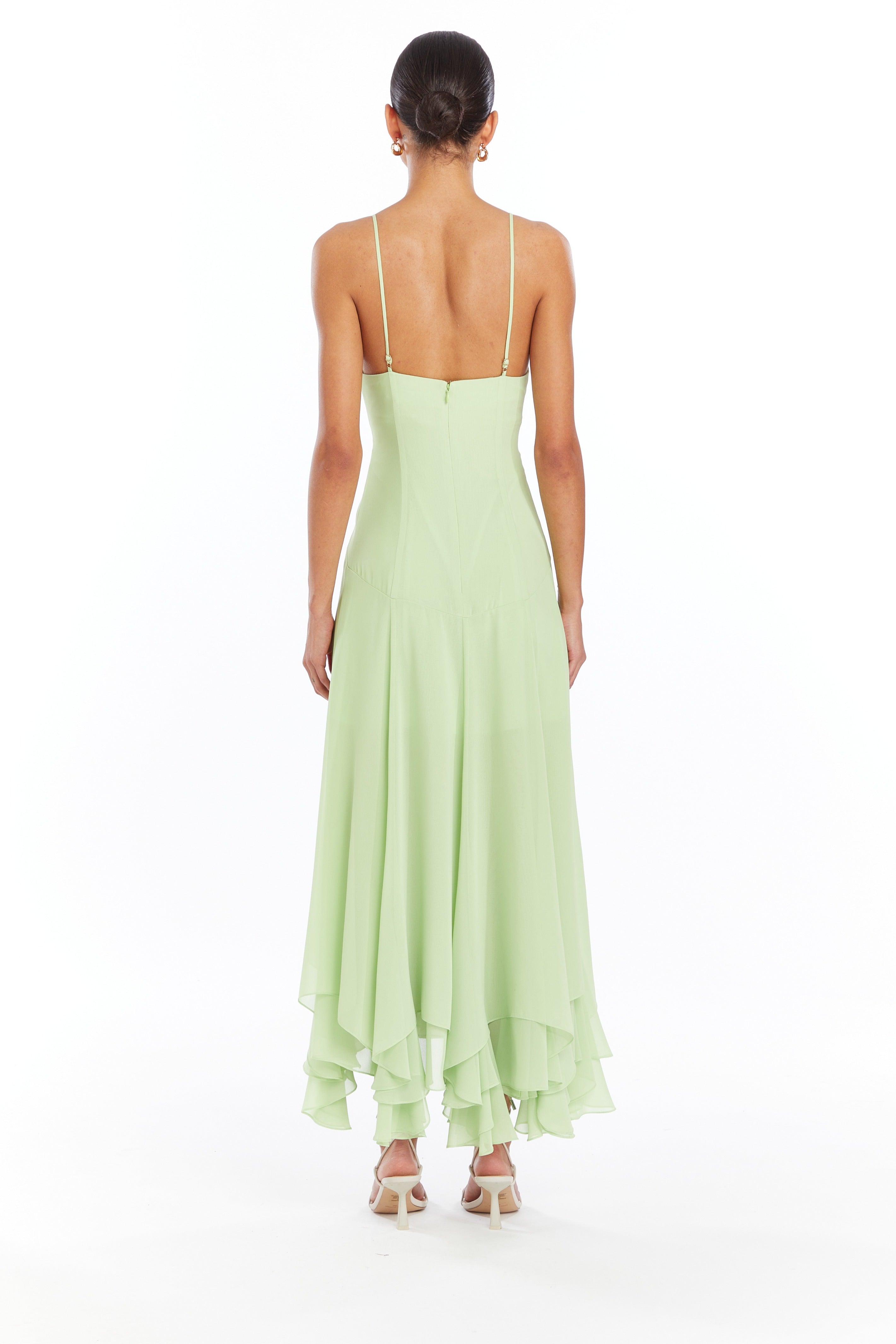 Girl in light green pink long dress, back facing.