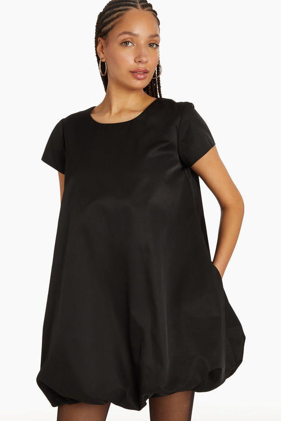 Girl in black dress with bubble bottom, front facing. view 1