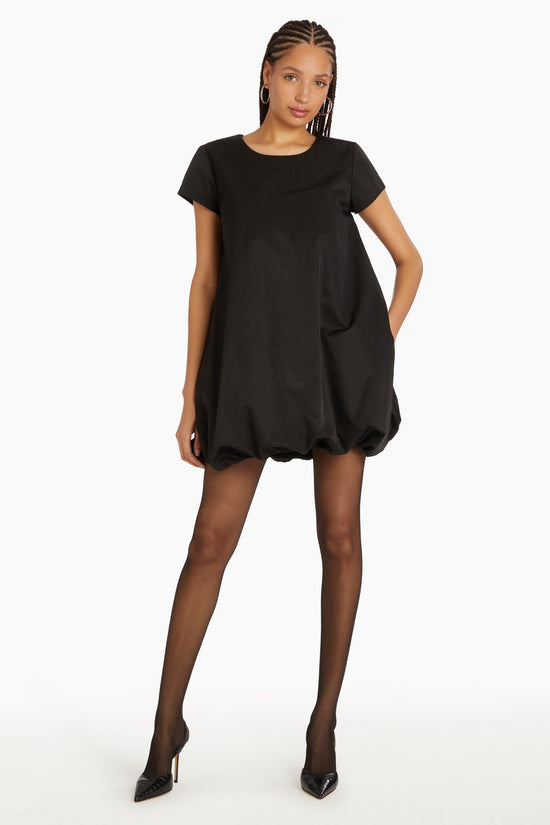 Girl in black dress with bubble bottom, front facing. view 1