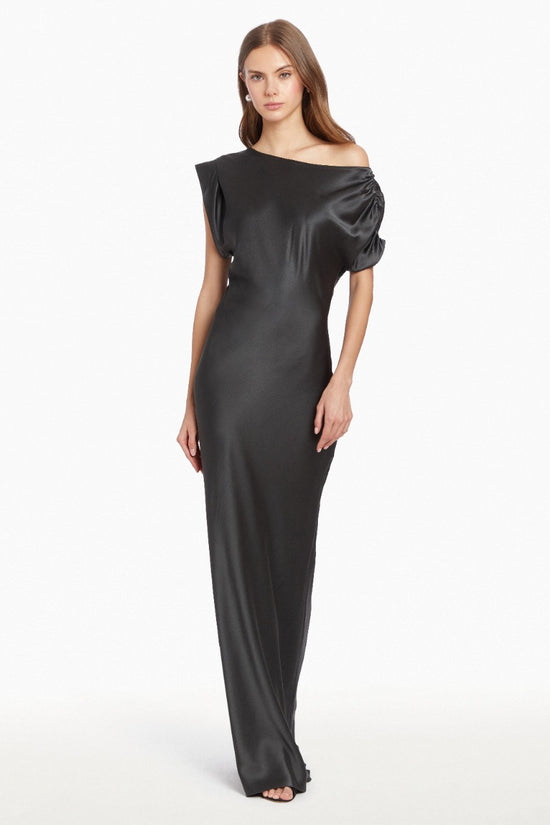 Girl in silk one shoulder black maxi dress, front facing. view 1