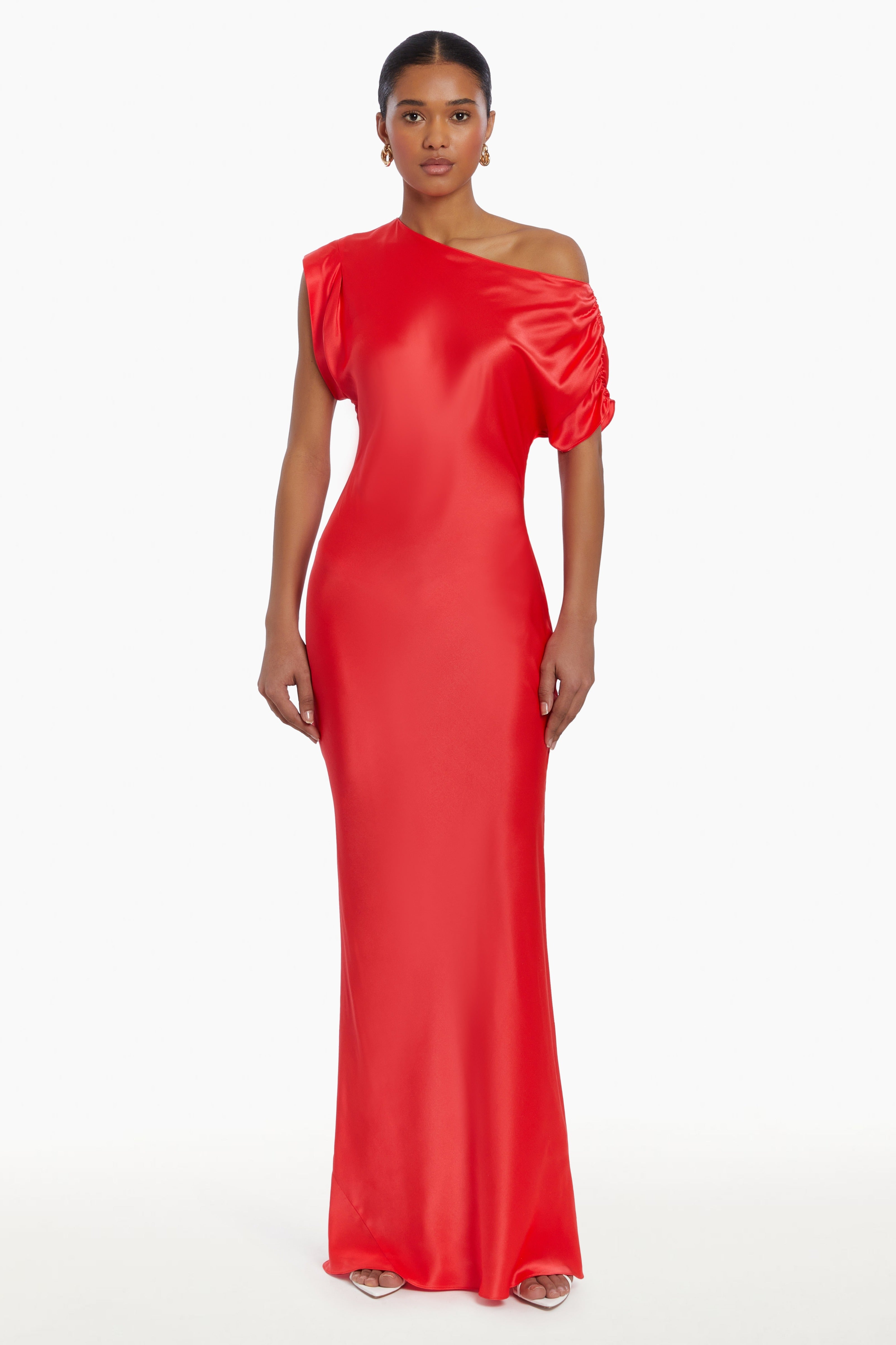 Girl in silk one shoulder red maxi dress, front facing.