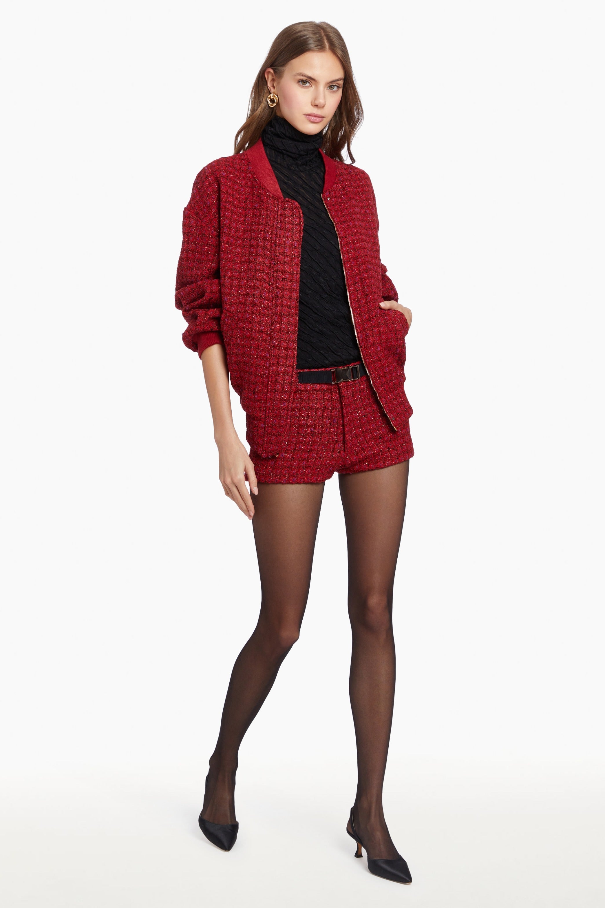 Girl in matching red houndstooth jacket and mini shorts set.