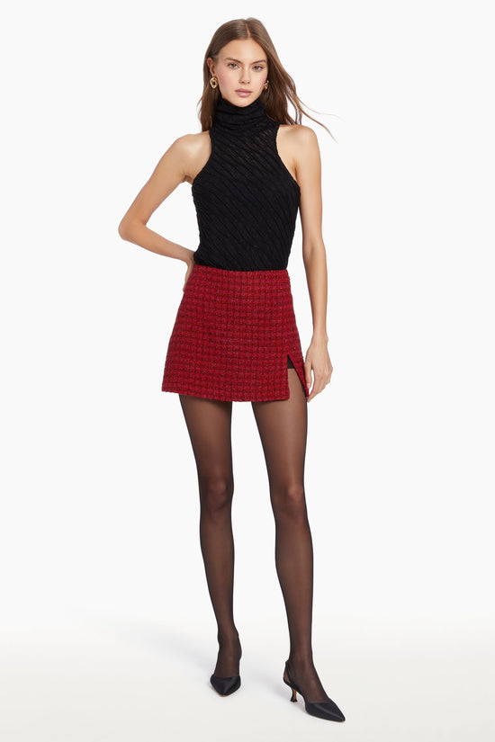 Girl in black top and red houndstooth mini skirt with slit. view 2