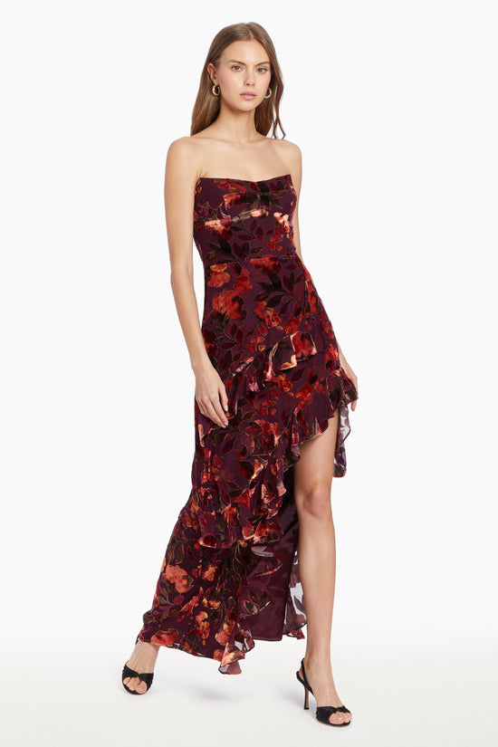 Girl in floral maxi dress with slit and ruffles, side facing. view 2