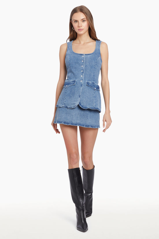 Girl in denim romper dress, front facing. view 1