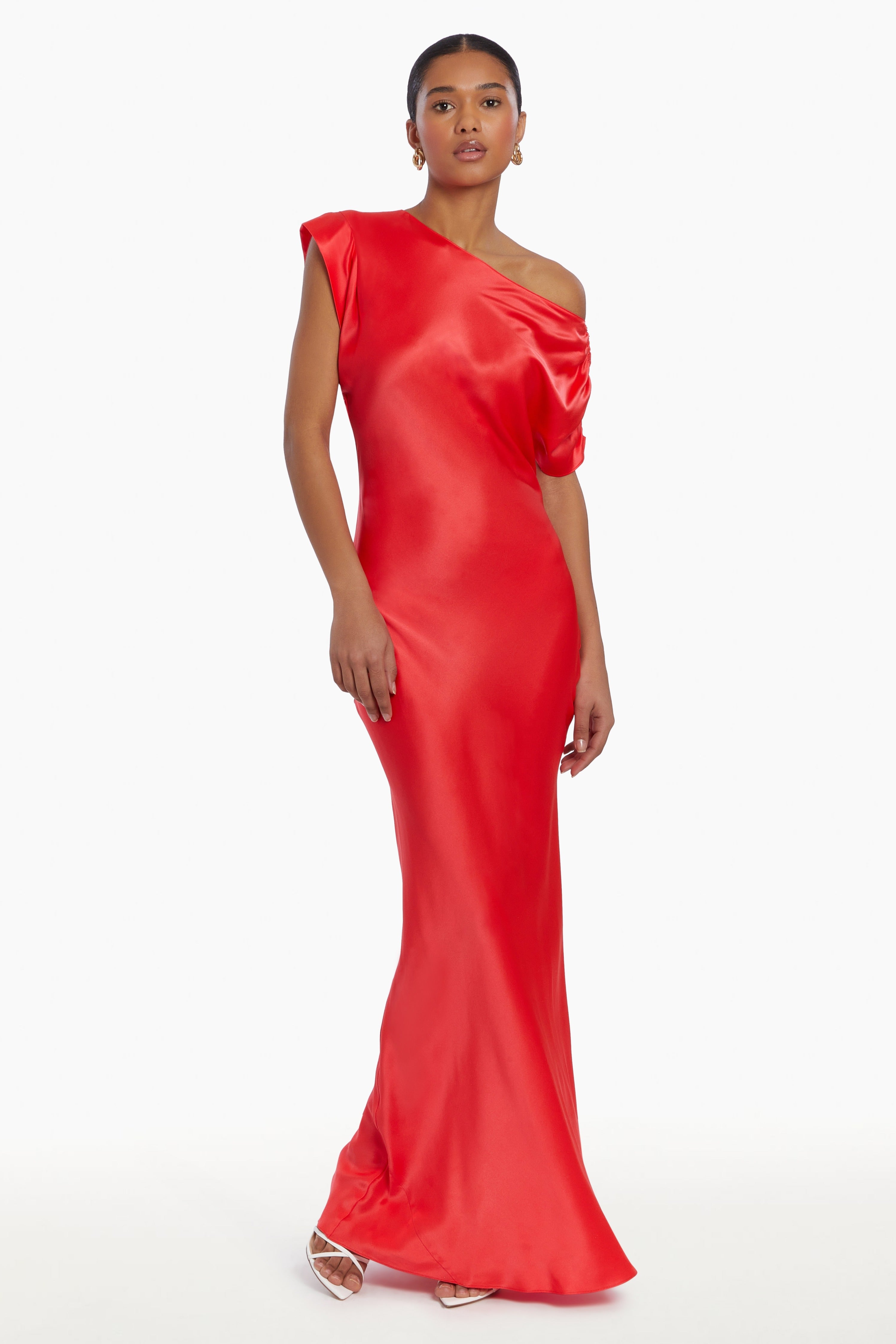 Girl in silk one shoulder red maxi dress, front facing.