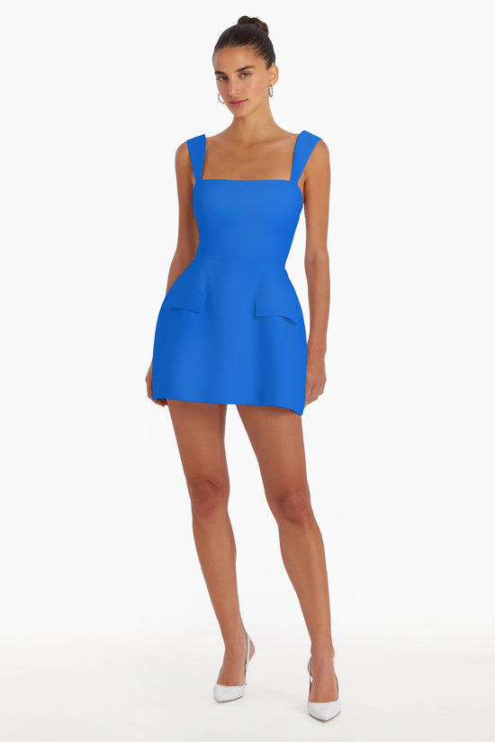 Girl in cobalt blue romper dress, front facing. view 1