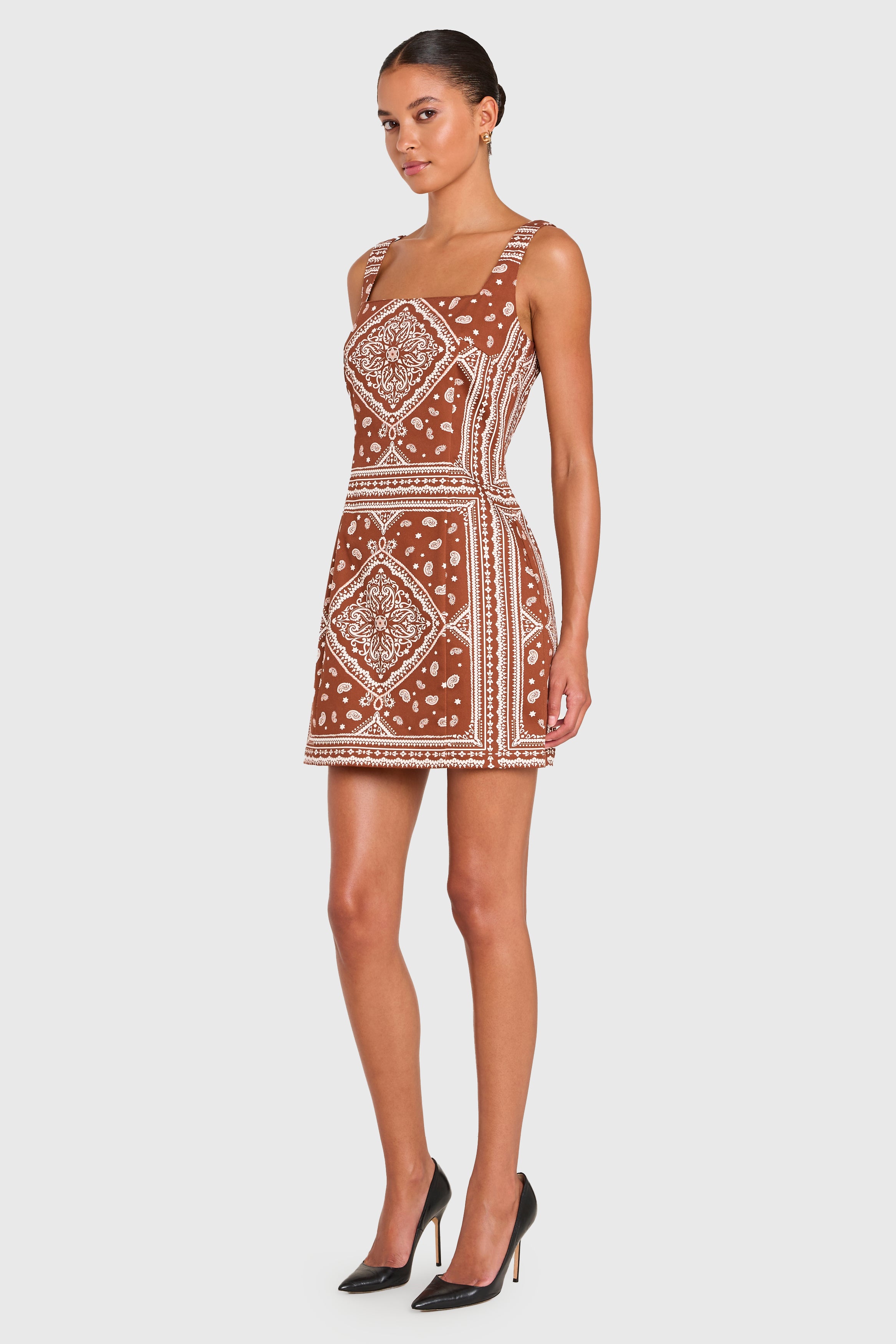 Woman wearing a patterned dress on a white background