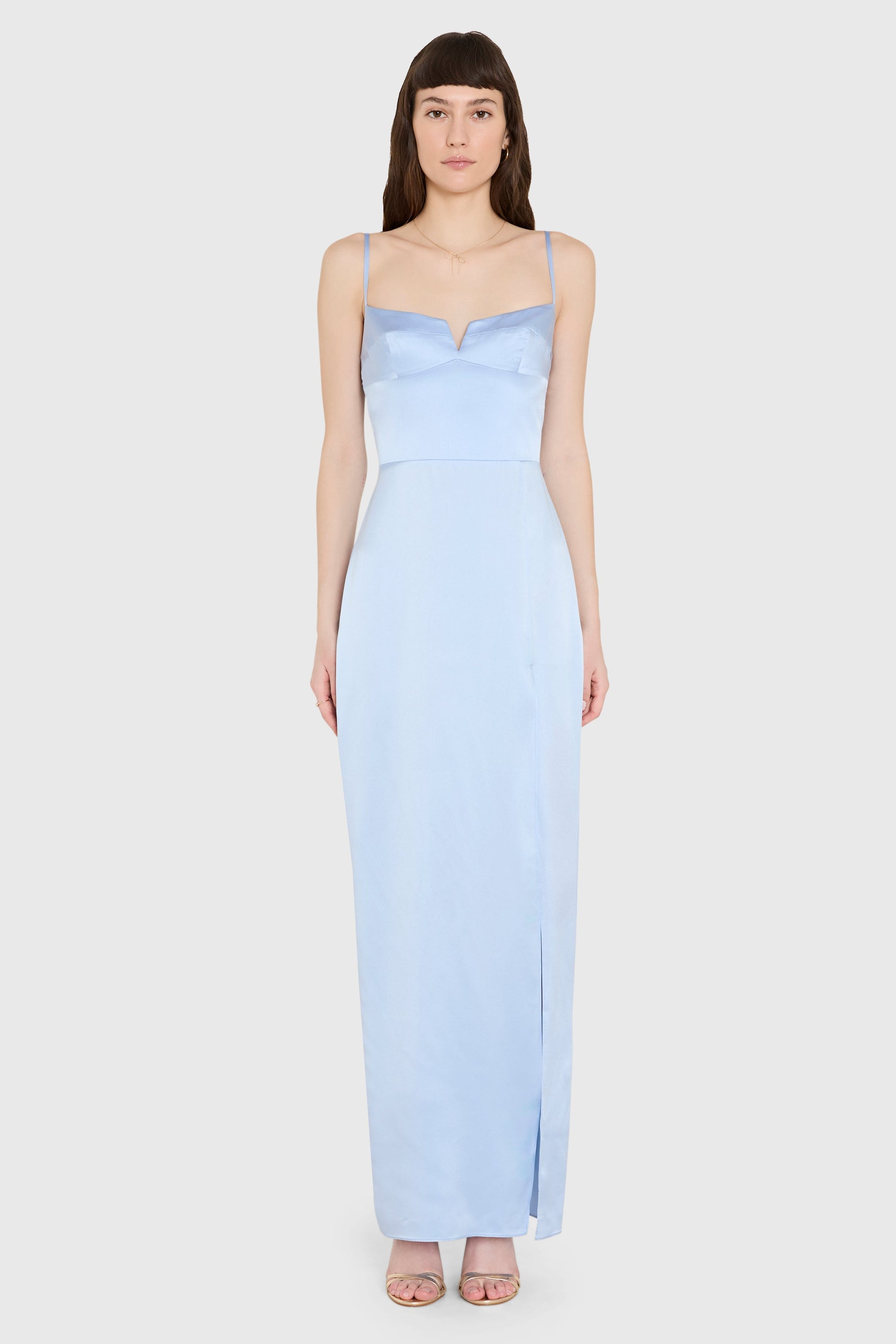 Woman wearing a light blue gown on a white background