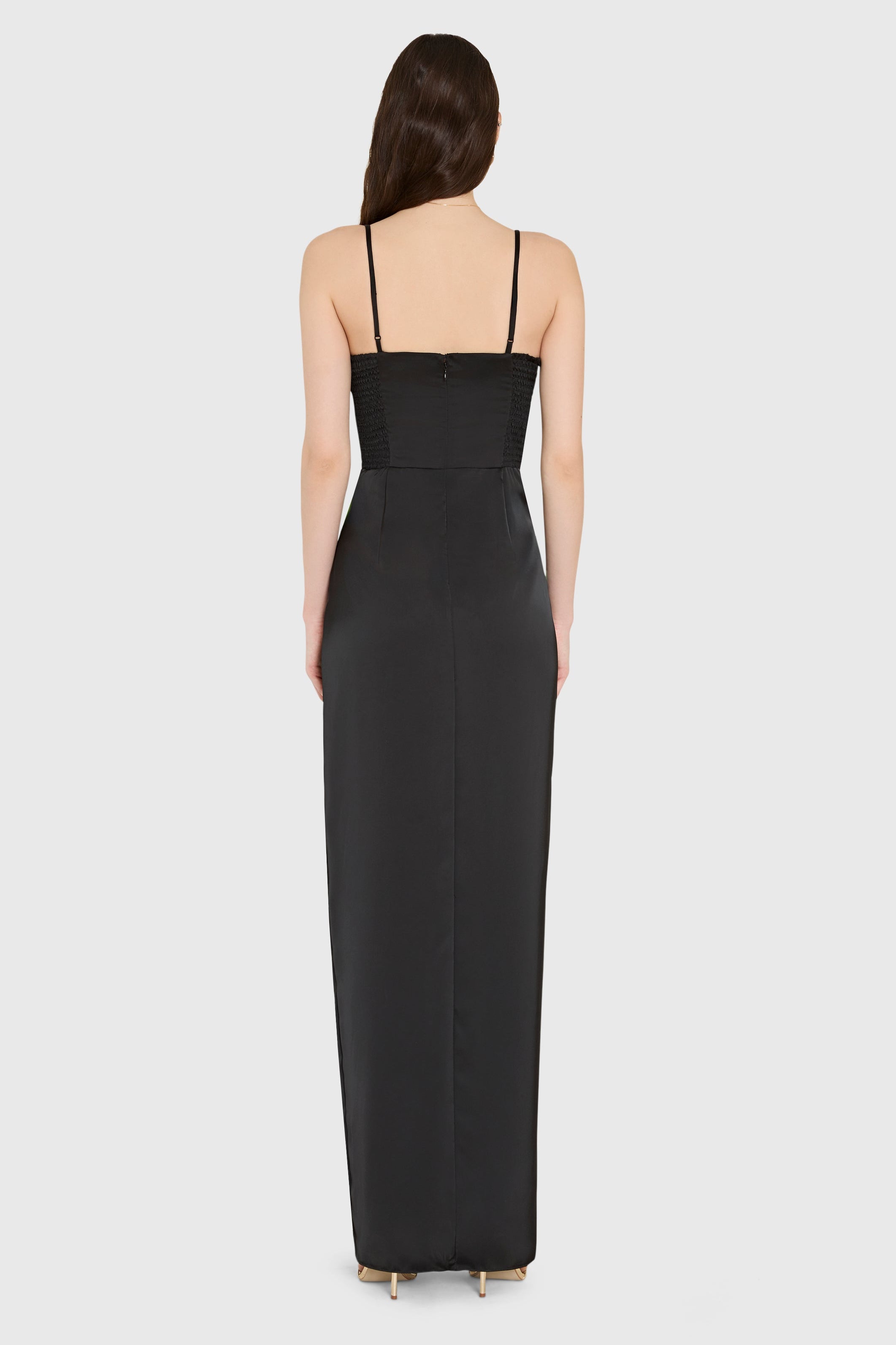 Woman wearing a black evening gown on a white background