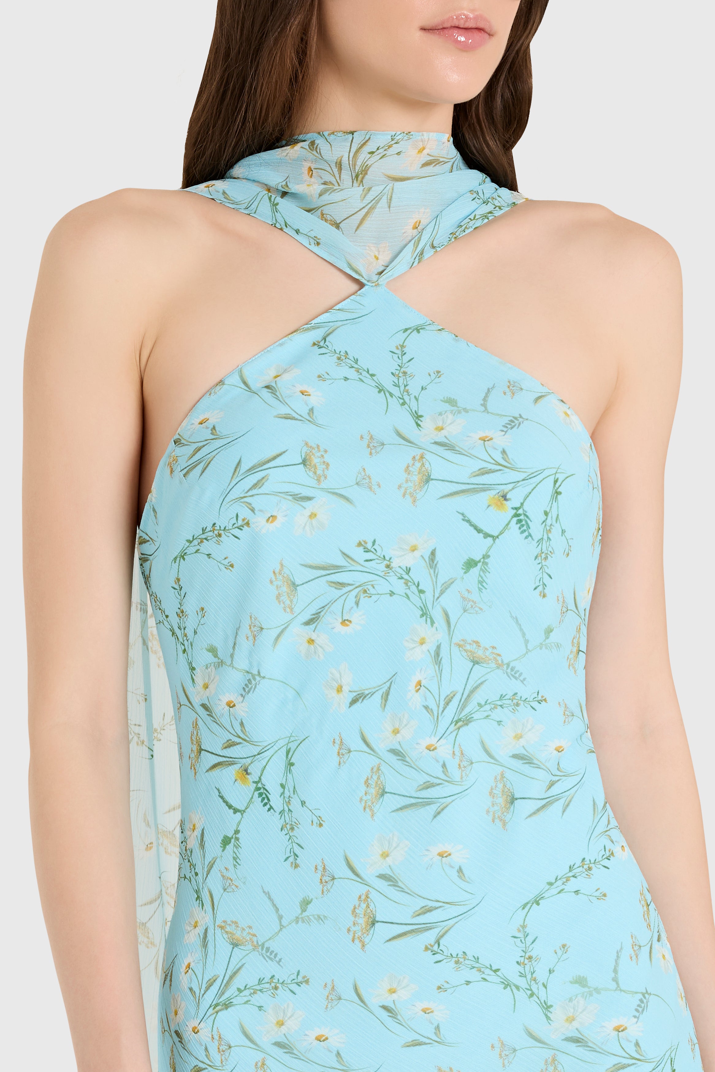 Light blue halter neck dress with floral pattern on a white background