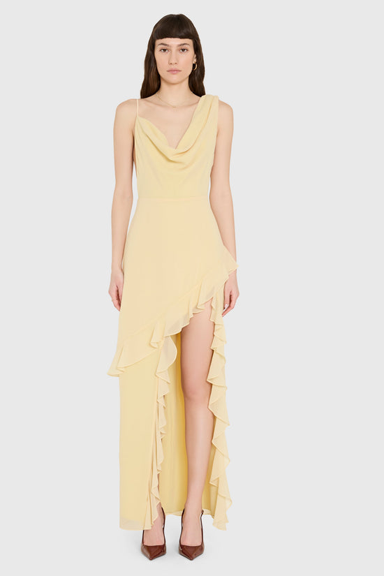 Woman wearing a yellow dress with a white background view 2