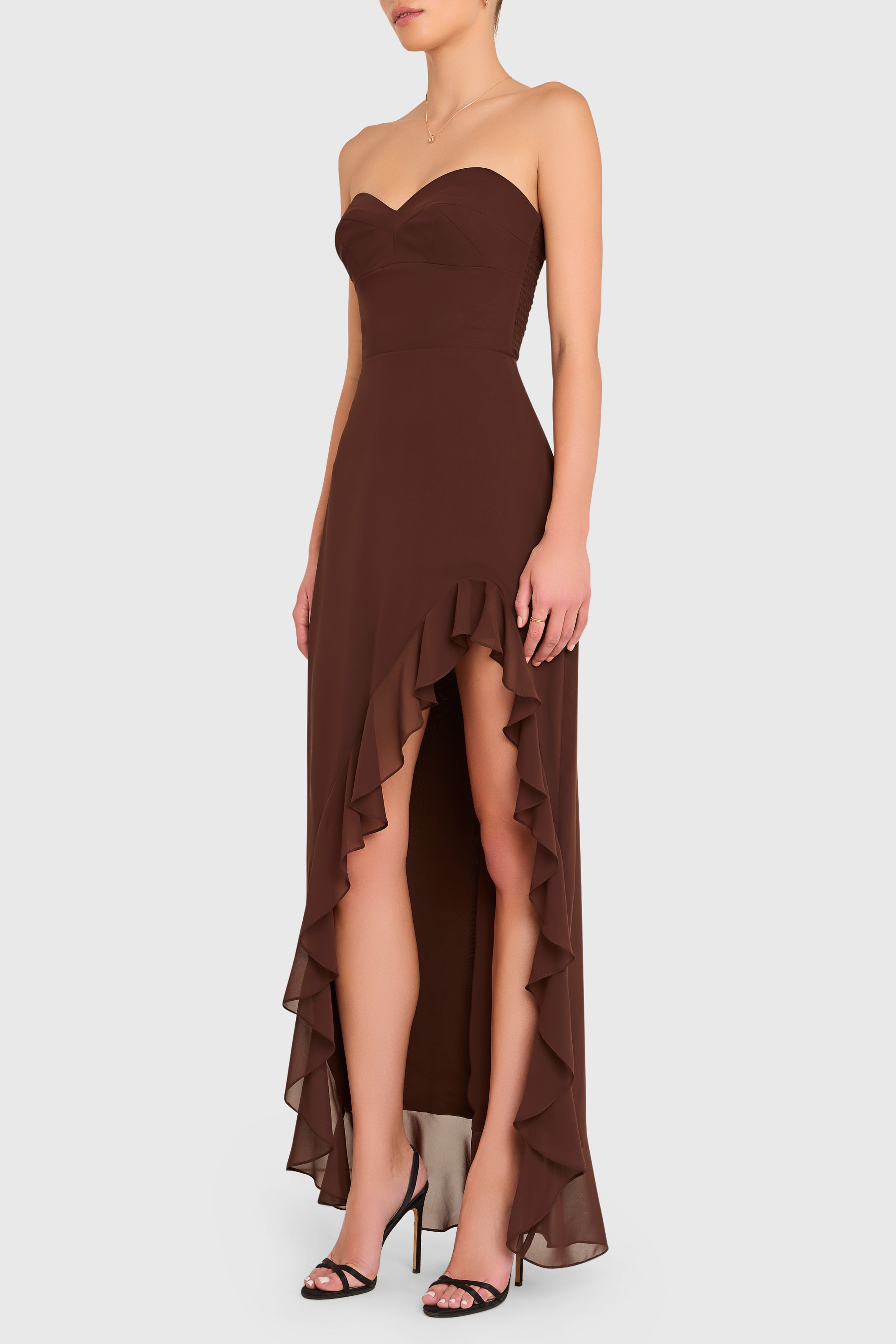 Brown strapless dress with ruffled layers on a white background