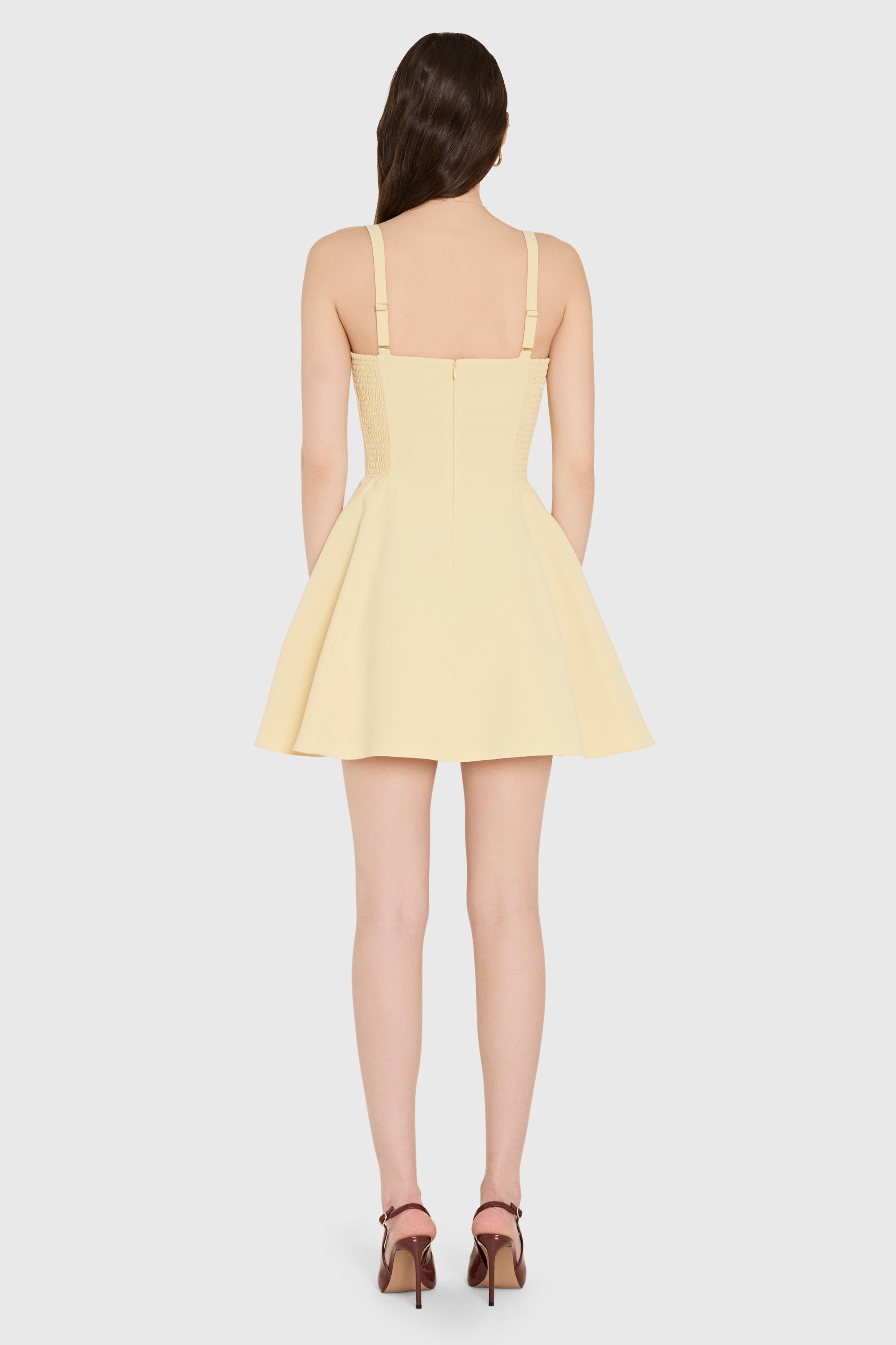 Yellow dress worn by a model on a white background