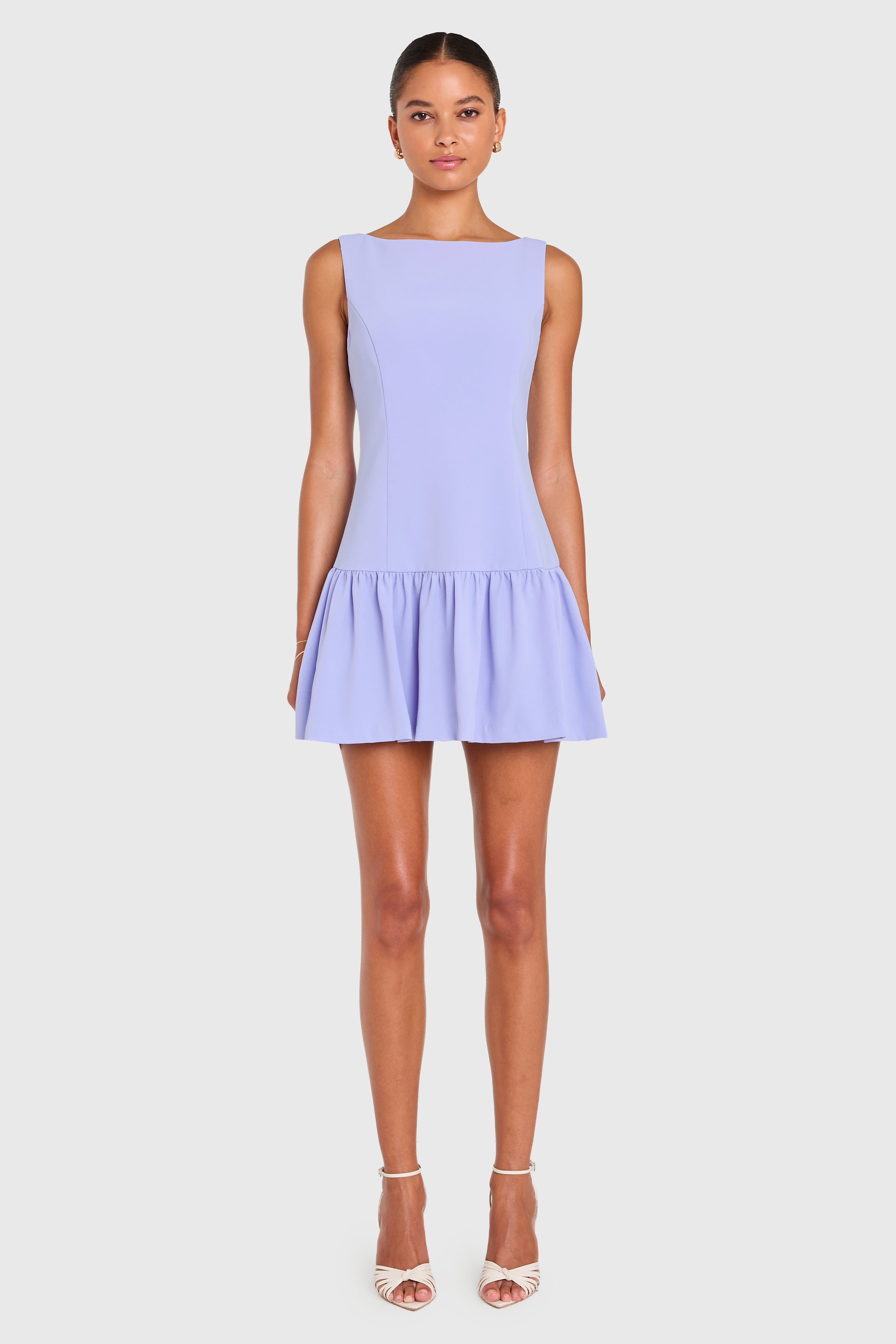 Woman wearing a light purple dress on a white background