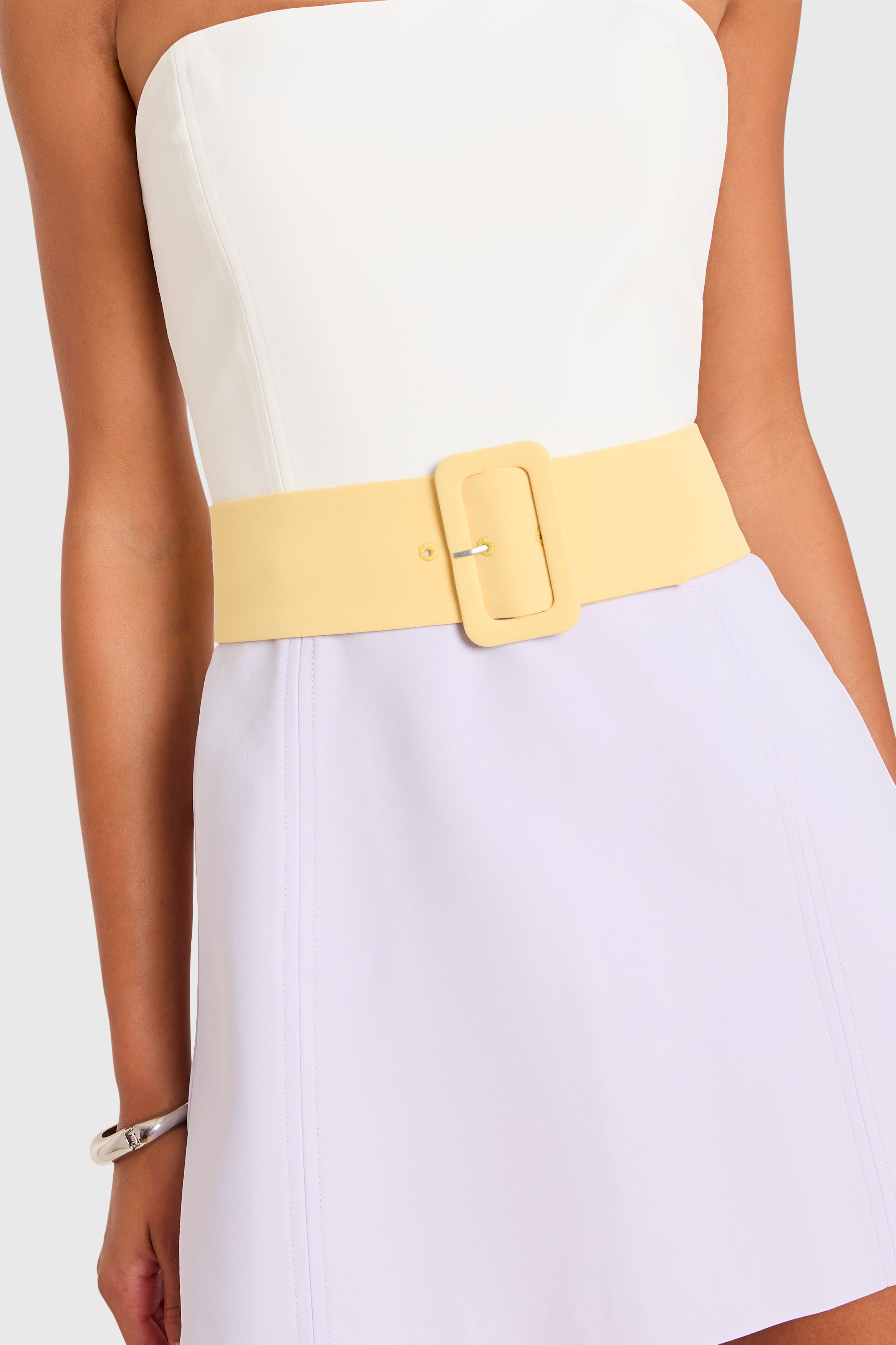 Amanda Uprichard |   Fae Romper in Ivory-Jasmiine-Daffodil. Model wears a color block mini dress against a white backgorund.