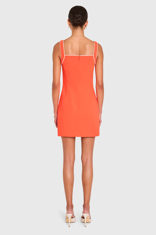 Amanda Uprichard |   Rosie Dress in Serrano. Model wears an orange mini dress against a white backgorund. view 3
