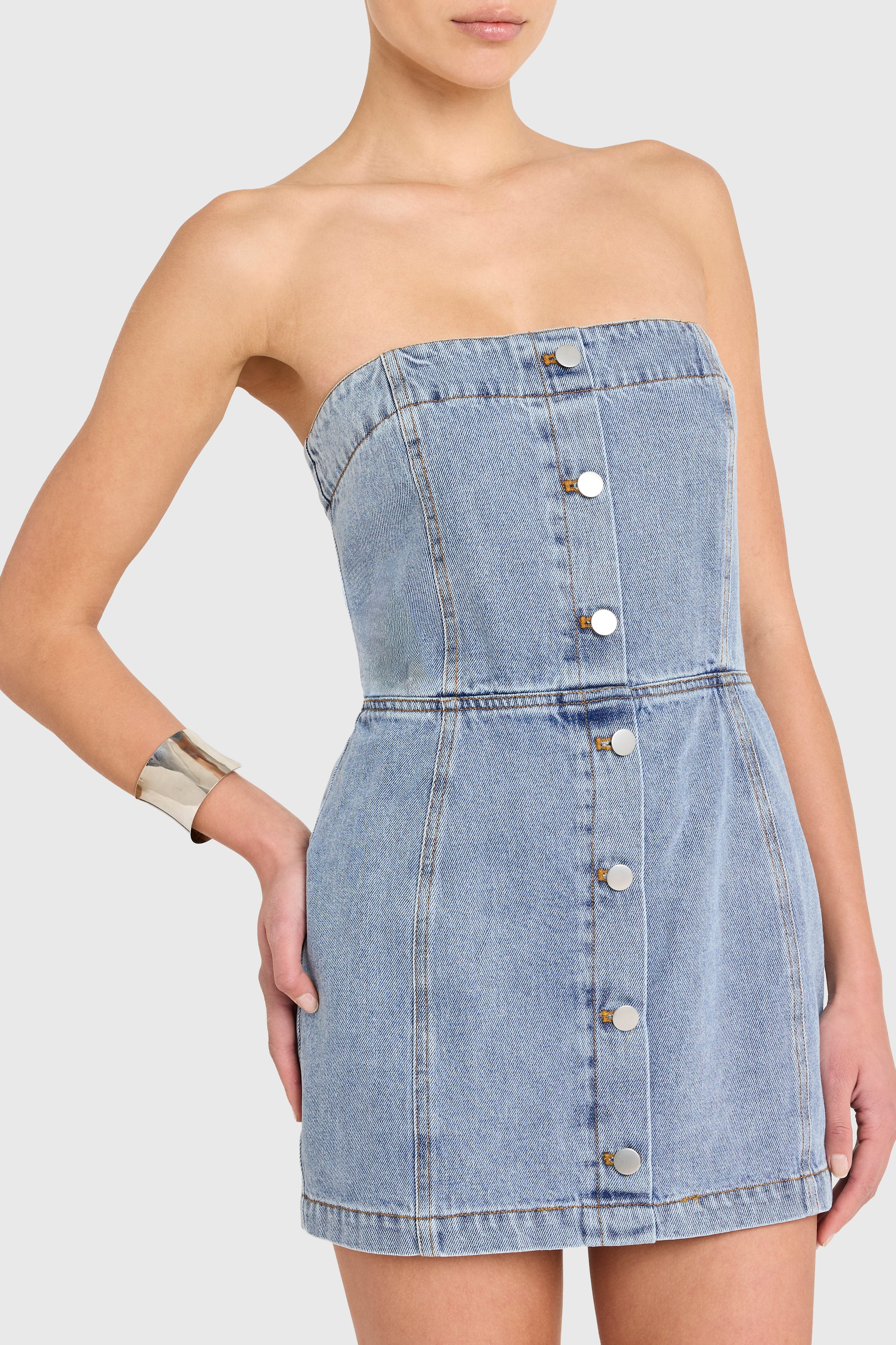 Denim strapless dress with button details on a white background