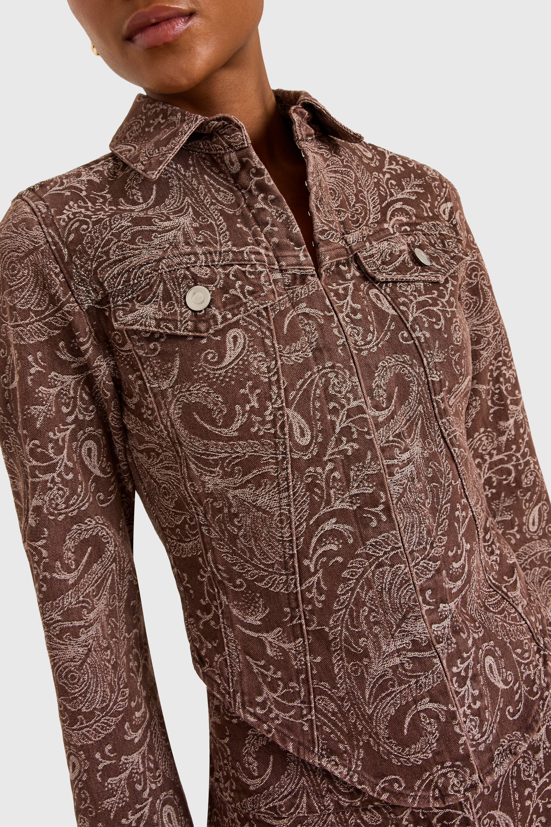 Brown paisley patterned shirt on a white background