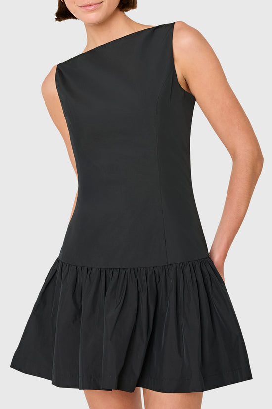 Black dress worn by a model on a white background