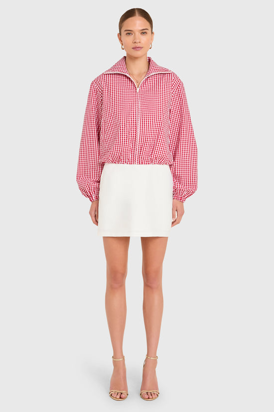 Amanda Uprichard |   Como Bomber Jacket in Red-White. Model wears a gingham jacket against a white backgorund. view 3