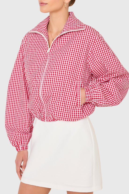 Amanda Uprichard |   Como Bomber Jacket in Red-White. Model wears a gingham jacket against a white backgorund. view 3