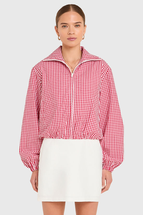Amanda Uprichard |   Como Bomber Jacket in Red-White. Model wears a gingham jacket against a white backgorund. view 2