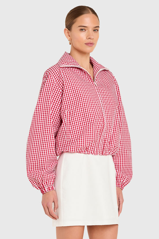 Amanda Uprichard |   Como Bomber Jacket in Red-White. Model wears a gingham jacket against a white backgorund. view 3