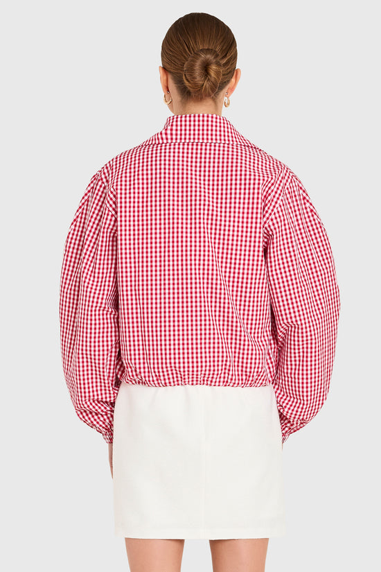 Amanda Uprichard |   Como Bomber Jacket in Red-White. Model wears a gingham jacket against a white backgorund. view 3