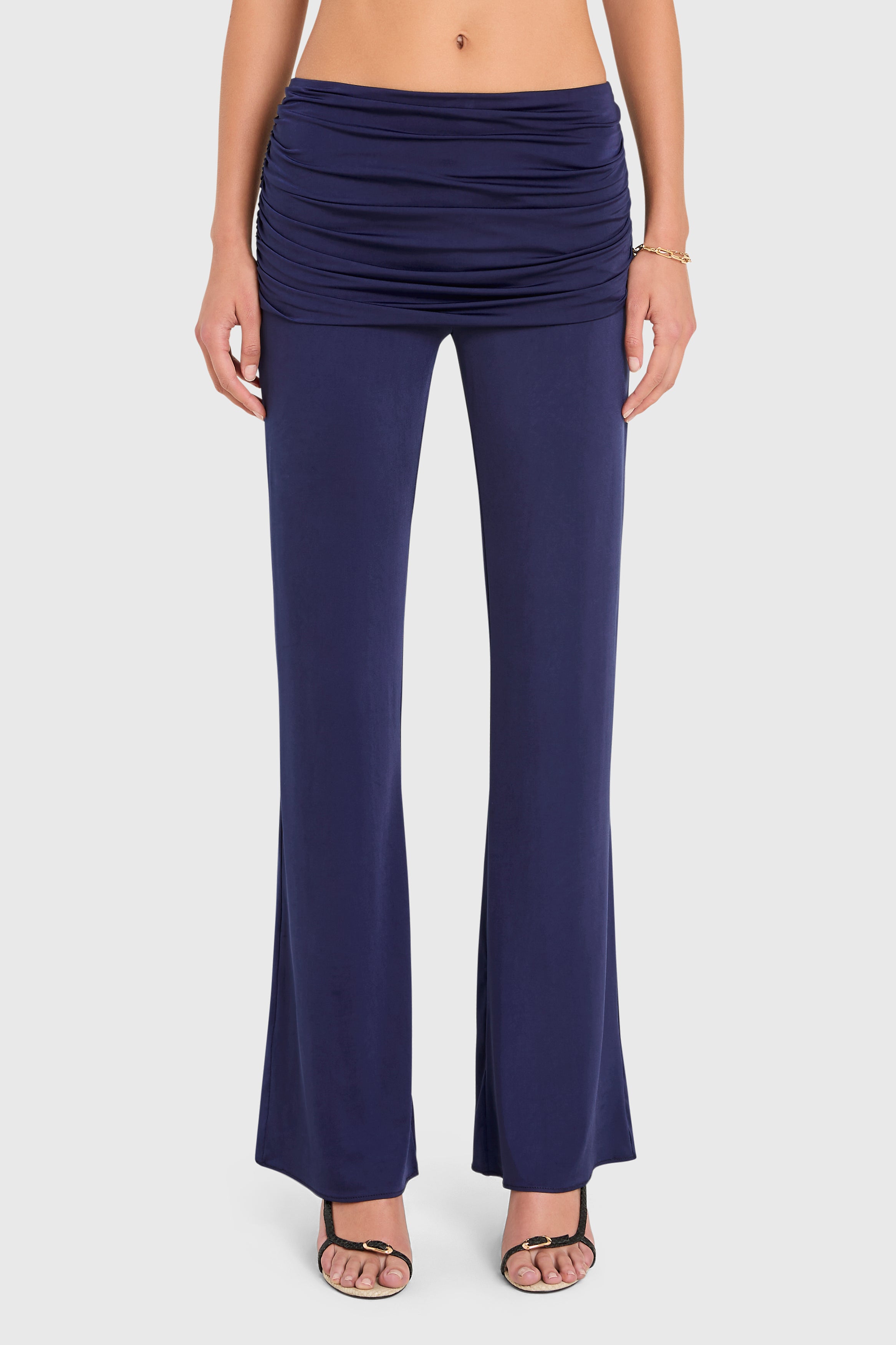 Amanda Uprichard |   Marcelle Pants in Navy Blue. Model wears blue pants against a white backgorund.