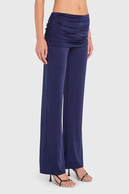 Amanda Uprichard |   Marcelle Pants in Navy Blue. Model wears blue pants against a white backgorund. view 3