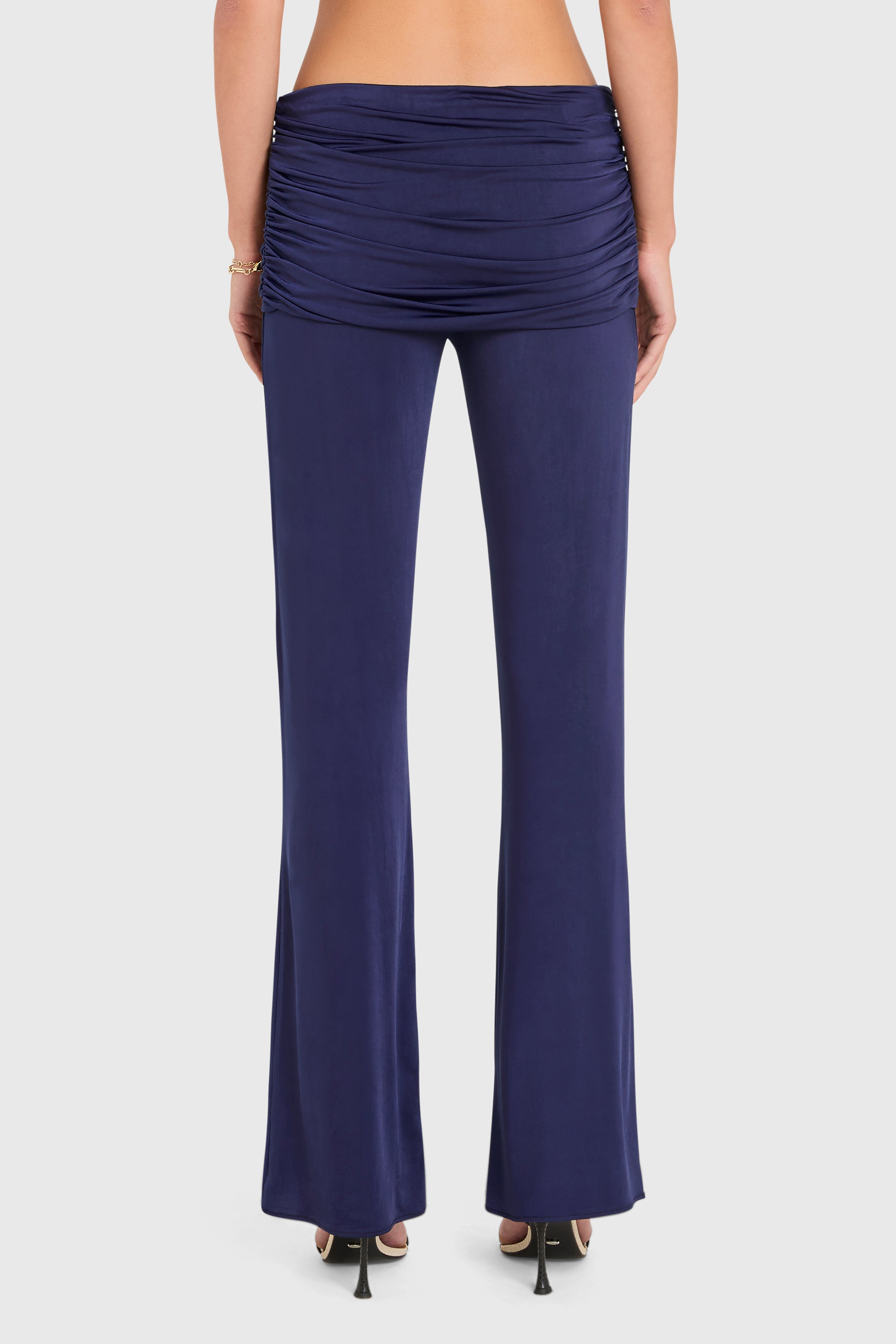 Amanda Uprichard |   Marcelle Pants in Navy Blue. Model wears blue pants against a white backgorund.