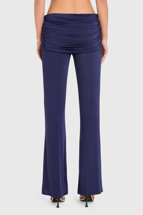 Amanda Uprichard |   Marcelle Pants in Navy Blue. Model wears blue pants against a white backgorund. view 3