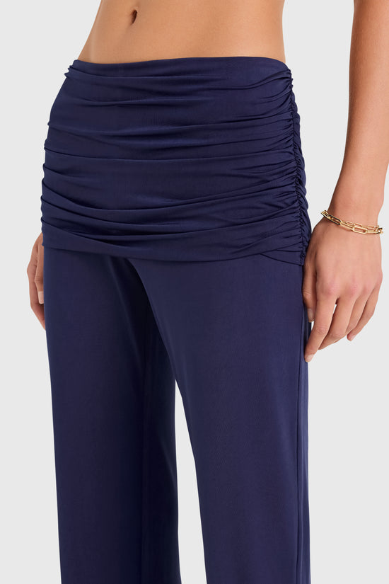 Amanda Uprichard |   Marcelle Pants in Navy Blue. Model wears blue pants against a white backgorund. view 3