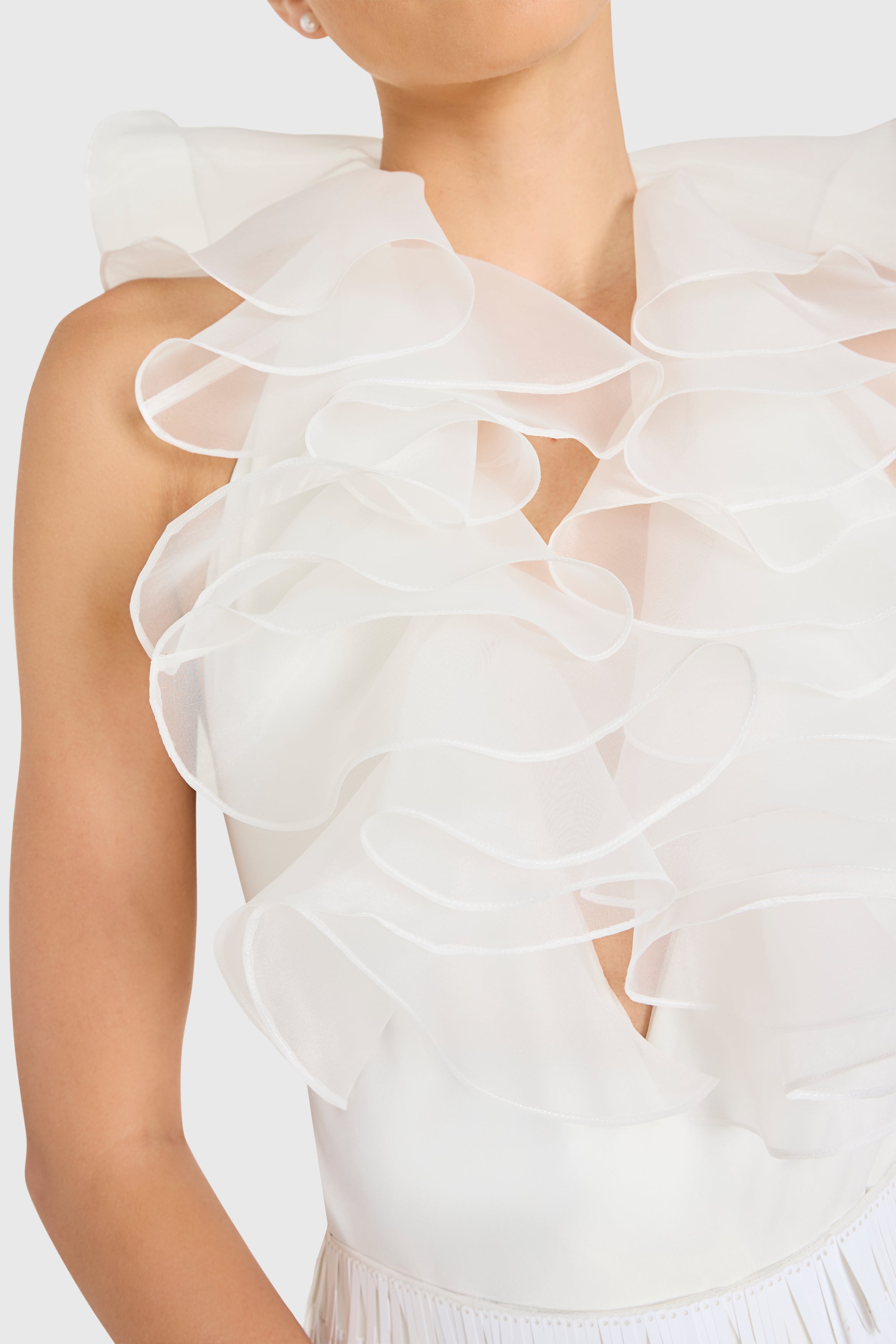 White ruffled top on a neutral background