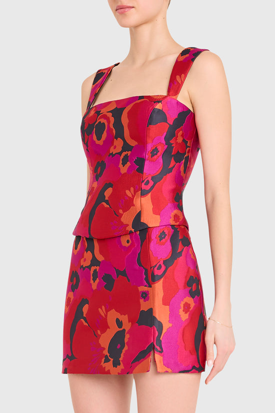 Woman wearing a vibrant red floral dress on a white background view 2