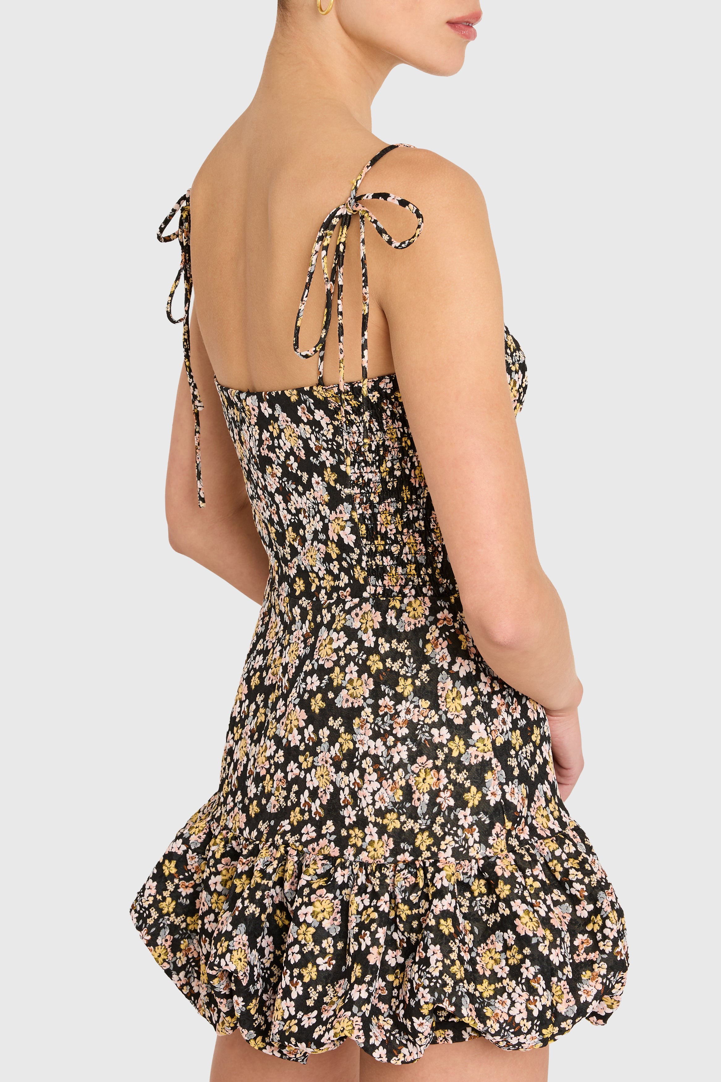Floral dress with tied straps on a plain background