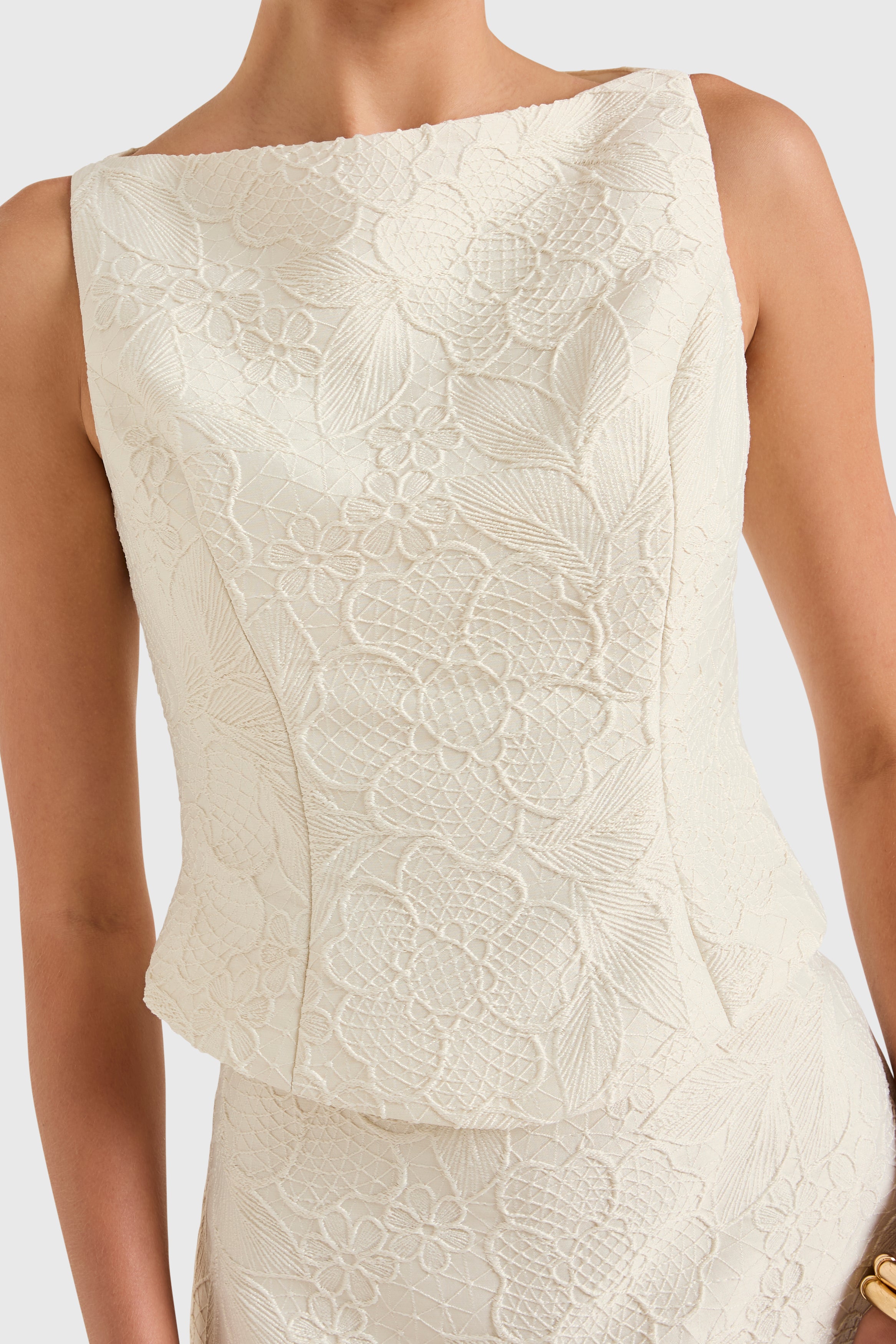 Amanda Uprichard |   Ines Top in Honeyblossom Brocade. Model wears a white sleeveless top against a white backgorund.