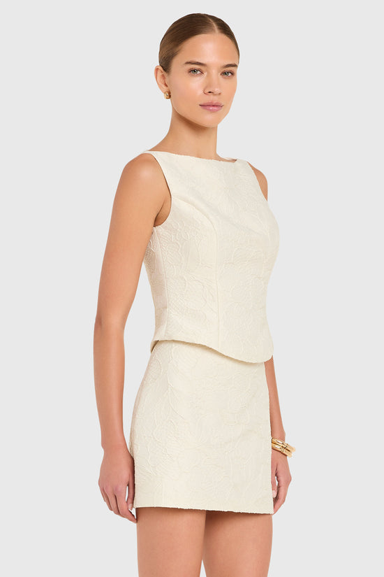 Amanda Uprichard |   Ines Top in Honeyblossom Brocade. Model wears a white sleeveless top against a white backgorund. view 3