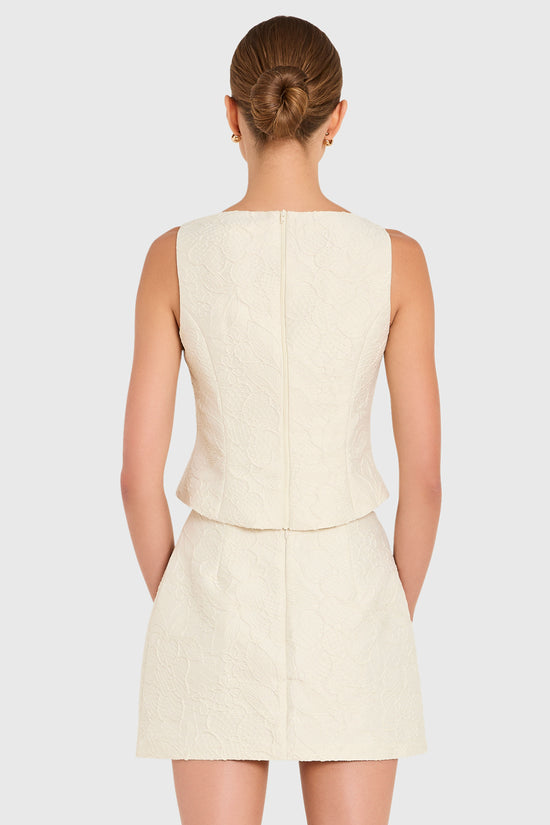 Amanda Uprichard |   Ines Top in Honeyblossom Brocade. Model wears a white sleeveless top against a white backgorund. view 3