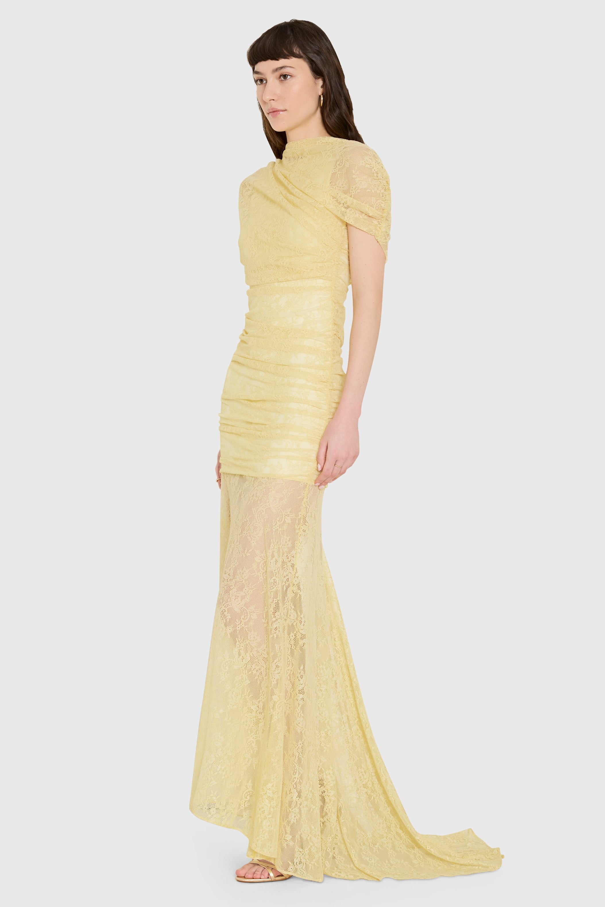 Woman wearing a yellow dress on a white background