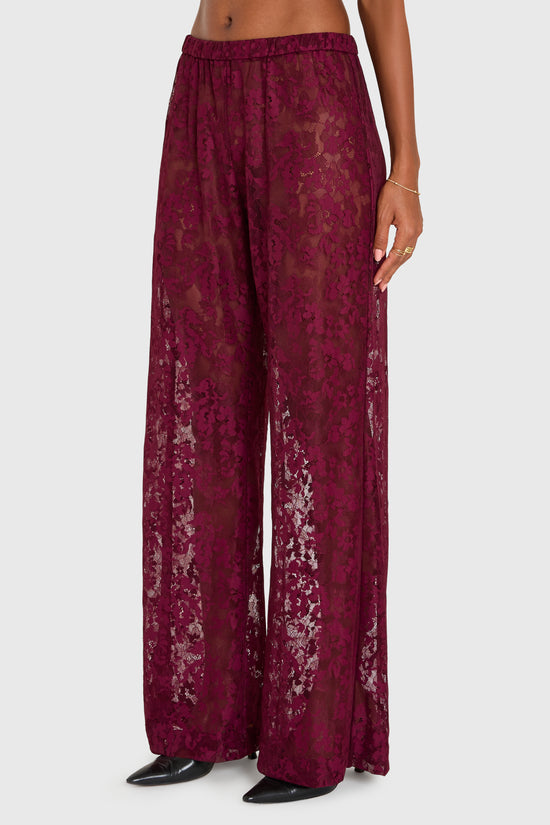 Maroon lace pants worn by a person on a white background view 2