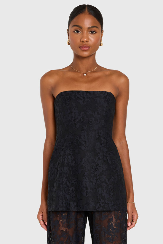 Woman wearing a black strapless lace dress on a white background view 2