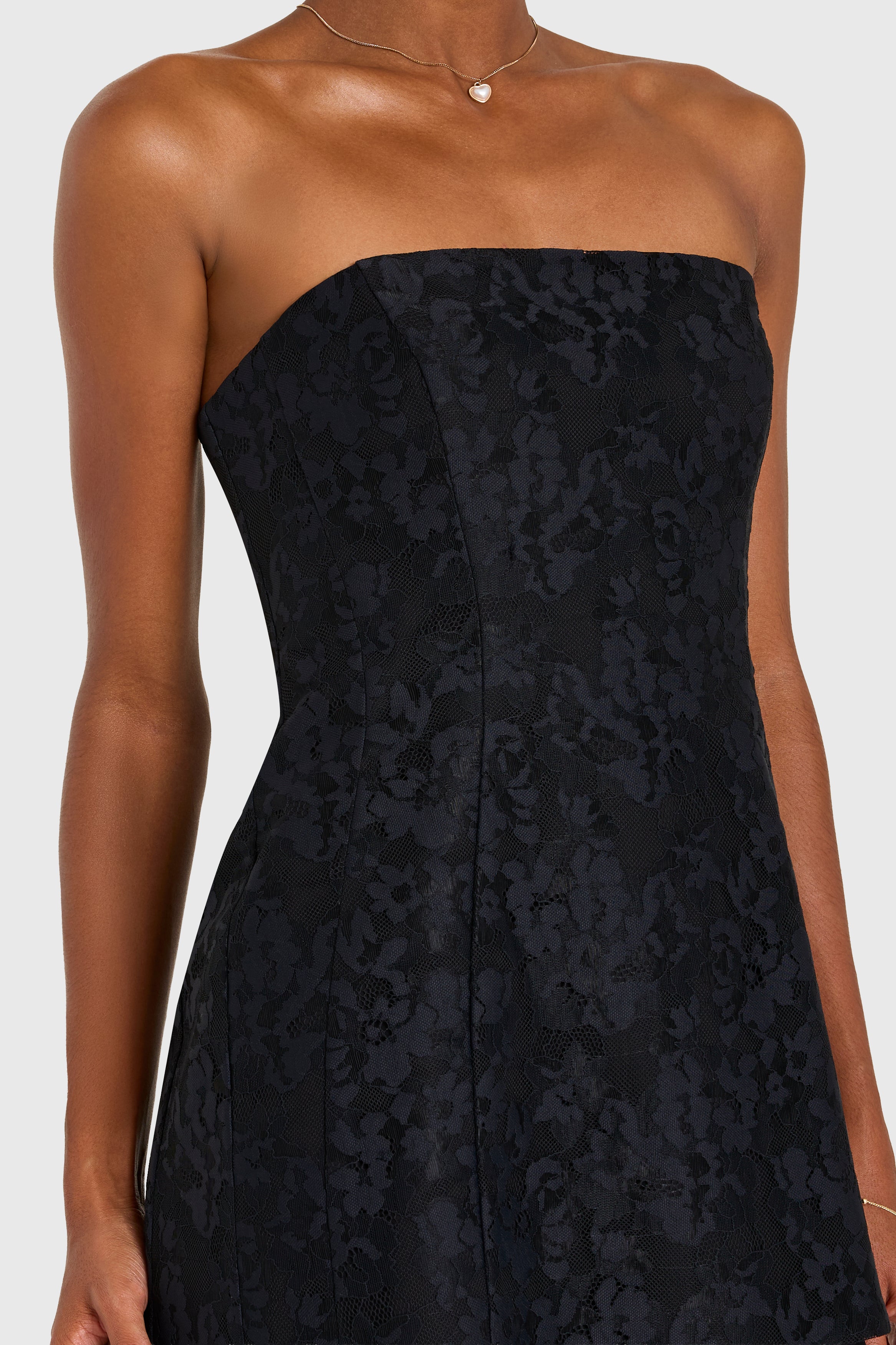 Black strapless dress with floral pattern on a white background