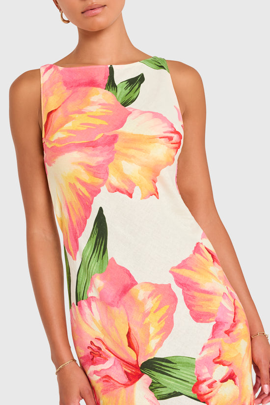 Amanda Uprichard |   Margo Midi Dress in Hibiscus Print. Model wears a floral midi dress against a white backgorund. view 3