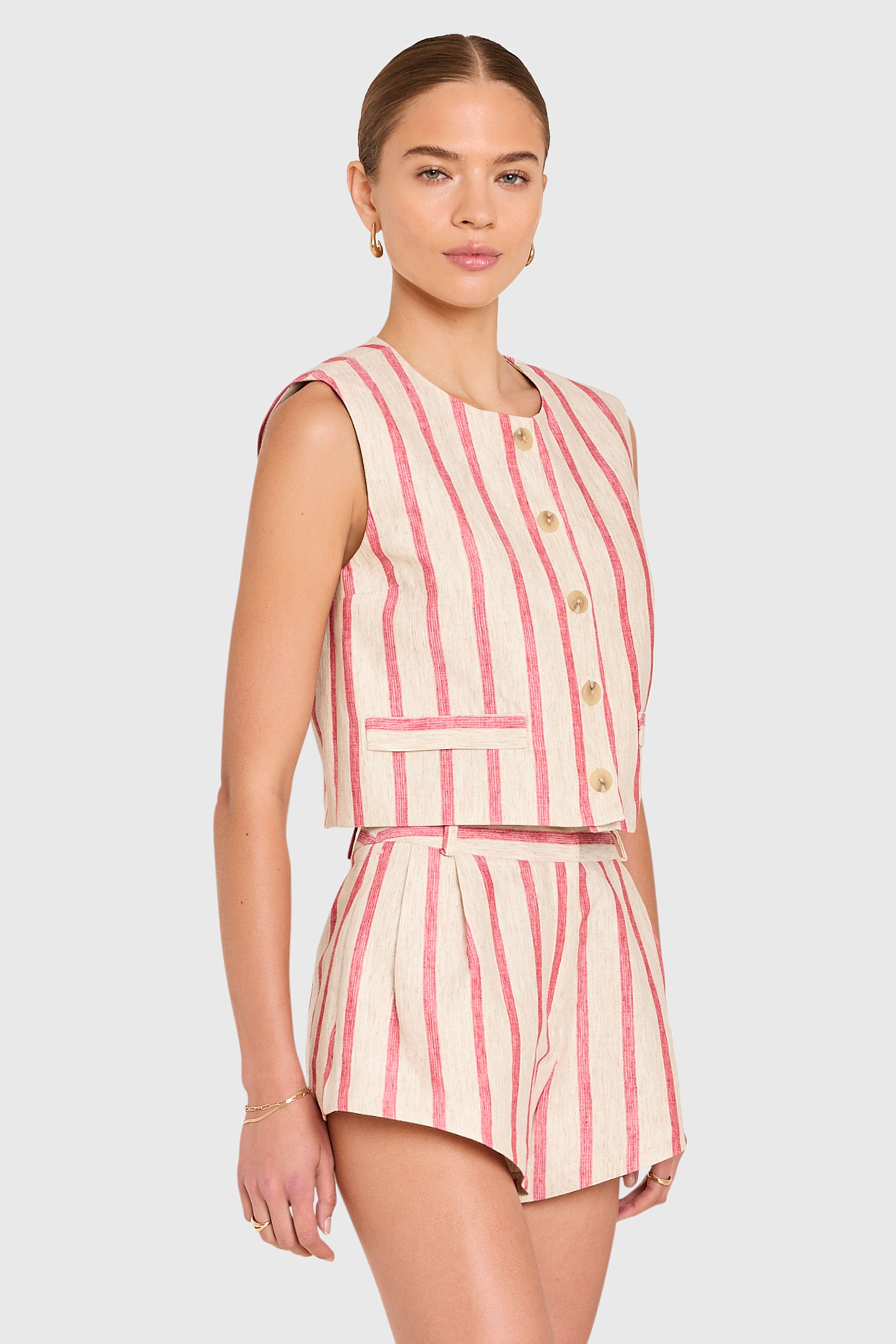 Amanda Uprichard |   Jeremiah Top in Red Stripe. Model wears a linen top against a white backgorund.